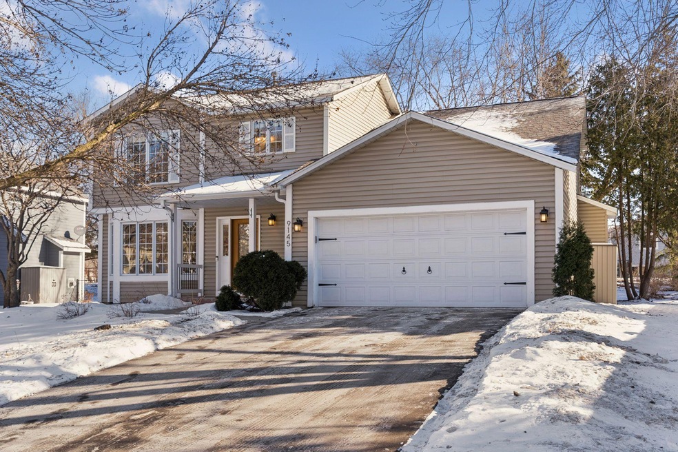 A two-storey home on Belvedere Drive, Eden Prairie, on a clear winter day with snow along the driveway