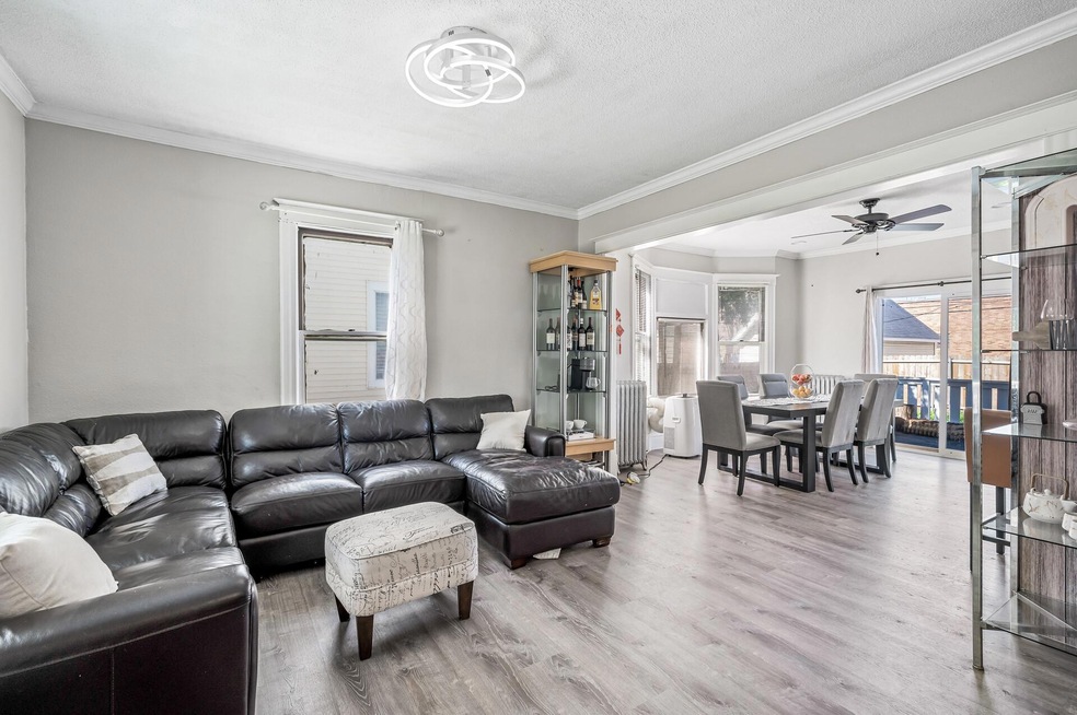 Living room and dining area of 3040 Elliot Avenue, Minneapolis, with wood floors and a bay window